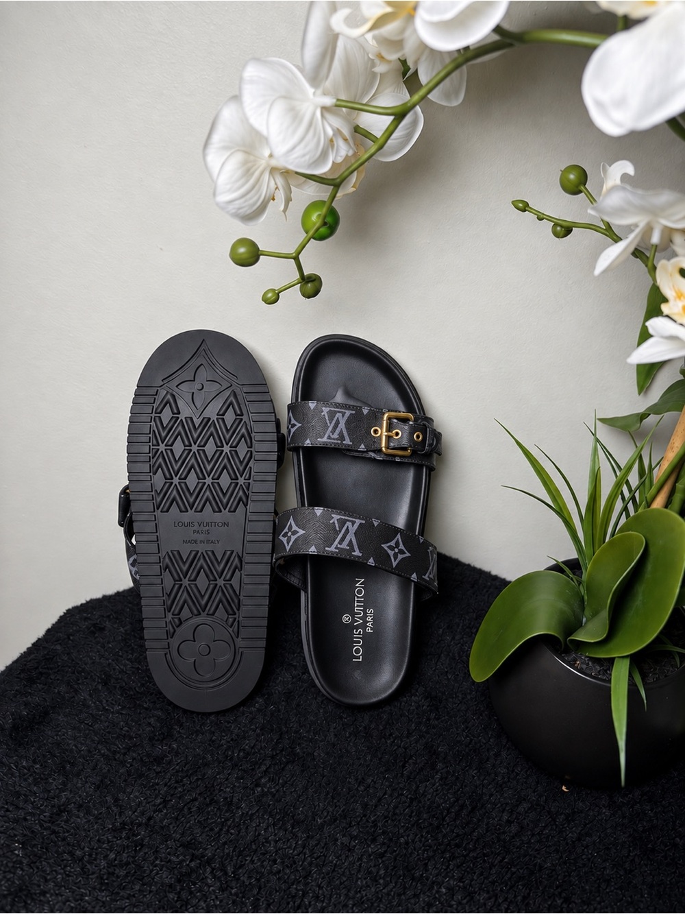 Women's slide sandals in black with signature monogram straps.